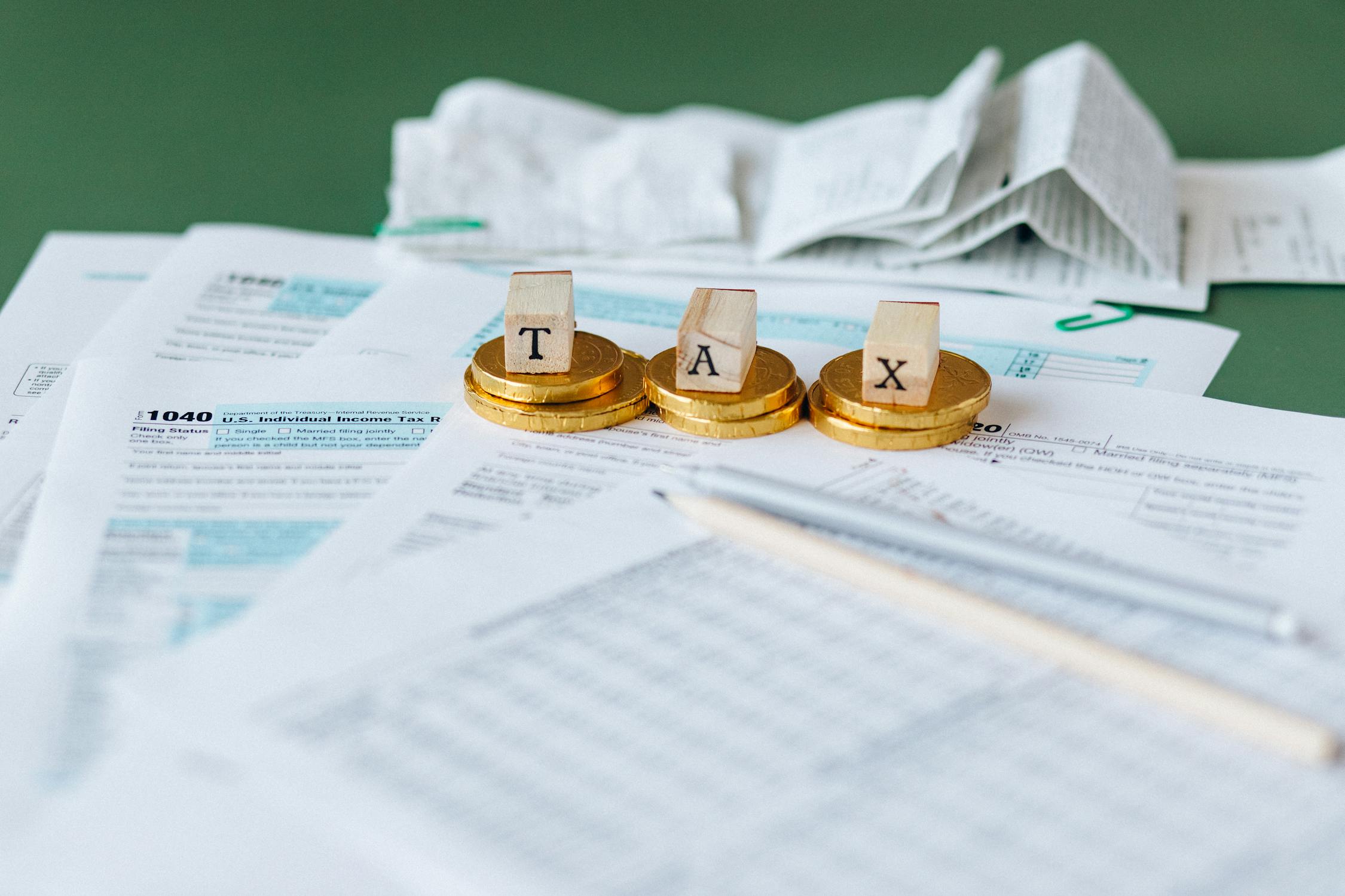 Tax documents and calculator on a table representing common tax mistakes young entrepreneurs make when starting a business